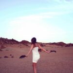 Image: A woman in the desert wearing a white dress. Blogpost title. Health: The Learning Never Ends.